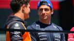 McLaren's British driver Lando Norris (L) speaks with Williams' Spaniah driver Carlos Sainz as they arrive for the 2025 Emilia Romagna Formula One Grand Prix at the Imola autodrome in Imola, on May 18, 2025. (Photo by Andrej ISAKOVIC / AFP)