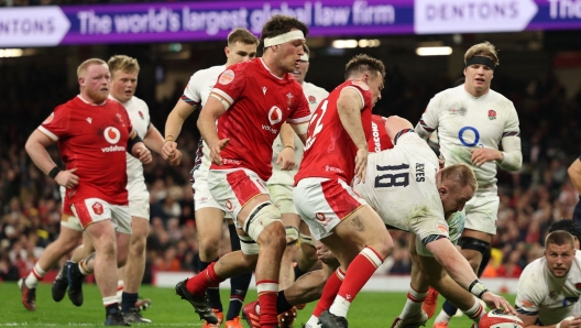 England's prop Joe Heyes scores a try during the Six Nations international rugby union match between Wales and England at the Principality Stadium in Cardiff, south Wales, on March 15, 2025. (Photo by Adrian Dennis / AFP) / RESTRICTED TO EDITORIAL USE. Use in books subject to Welsh Rugby Union (WRU) approval.
