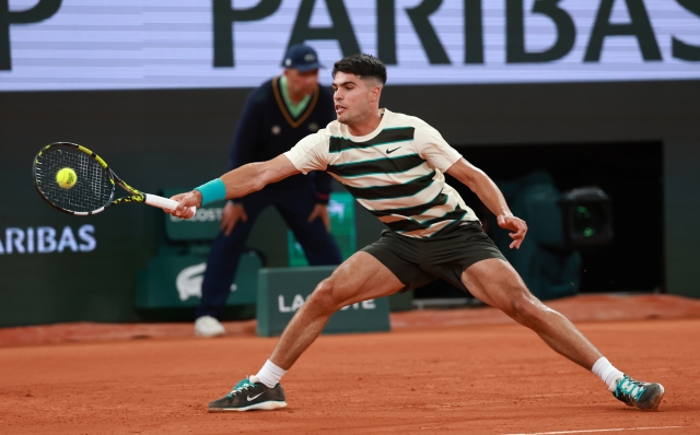 PARIS, FRANCE - MAY 28: Carlos Alcaraz of Spain plays a forehand against Fabian Marozsan of Hungary during the Men's Singles Second Round match on Day Four of the 2025 French Open at Roland Garros on May 28, 2025 in Paris, France. (Photo by Clive Brunskill/Getty Images)