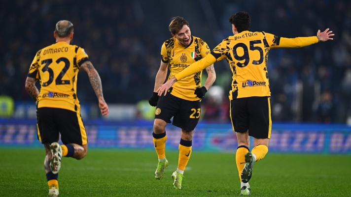 ROME, ITALY - DECEMBER 16: Nicolo Barella of FC Internazionale celebrates with Alessandro Bastoni and Federico Dimarco after scoring the goal during the Serie A match between SS Lazio and FC Internazionale at Stadio Olimpico on December 16, 2024 in Rome, Italy. (Photo by Mattia Ozbot - Inter/Inter via Getty Images)